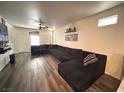 Cozy living room with luxury vinyl floors and a large sectional sofa at 5591 La Perla Ct, Las Vegas, NV 89122