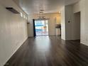 Spacious living room with modern dark flooring and sliding door to outdoor space at 5591 La Perla Ct, Las Vegas, NV 89122