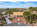 Expansive property with a circular driveway, lush landscaping, and mountain views at 5829 W Patrick Ln, Las Vegas, NV 89118