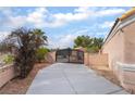Gated driveway leading to a single-story home, ensuring privacy and security at 5829 W Patrick Ln, Las Vegas, NV 89118