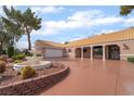 Single-story home featuring a circular driveway, fountain, and a covered porch at 5829 W Patrick Ln, Las Vegas, NV 89118