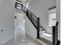 Bright foyer with tile flooring and staircase leading to the upper level at 681 Stone Hammer Ave, Las Vegas, NV 89183
