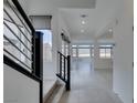 Bright living room featuring tile floors, recessed lighting and staircase at 681 Stone Hammer Ave, Las Vegas, NV 89183