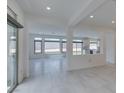 Bright living room with tile flooring, recessed lights and access to the backyard at 681 Stone Hammer Ave, Las Vegas, NV 89183