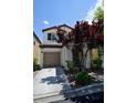 Charming two-story home featuring a well-manicured front yard and attached garage at 7089 Oberling Bay Ave, Las Vegas, NV 89113