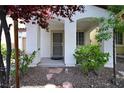 Inviting front porch with decorative plants and stone accents for added curb appeal at 7089 Oberling Bay Ave, Las Vegas, NV 89113