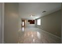 Spacious living room featuring neutral walls and easy access to the kitchen at 7089 Oberling Bay Ave, Las Vegas, NV 89113