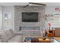 Inviting living room featuring a fireplace, modern decor, and neutral tones at 8668 Hartmont St, Las Vegas, NV 89166
