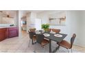 Open dining room features a dining table set for six, an art wall, and easy kitchen access at 8872 Perfect Diamond Ct, Las Vegas, NV 89129