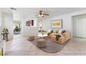 Bright living room features a comfortable sofa, stylish decor, and tile flooring throughout at 8872 Perfect Diamond Ct, Las Vegas, NV 89129