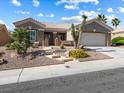 Charming single-story home showcasing desert landscaping and a two-car garage at 10417 Sea Palms Ave, Las Vegas, NV 89134