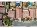 Aerial shot of homes with tile roofs, backyard pools and desert landscaping at 11091 Parete Ct, Las Vegas, NV 89141