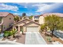 Lovely single-Gathering home boasts a two-car garage and neat landscaping at 11091 Parete Ct, Las Vegas, NV 89141