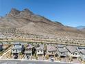 Panoramic aerial view of a neighborhood nestled against majestic mountains at 11652 Desert Hollow Ave, Las Vegas, NV 89138