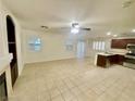 Bright living area features tile flooring, shutters, and seamlessly connects to kitchen at 11953 Haven St, Las Vegas, NV 89183