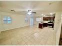 Open-concept living area with tile flooring, shutters, and bright natural light at 11953 Haven St, Las Vegas, NV 89183