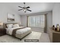 Serene bedroom with neutral tones, ceiling fan, plantation shutters, and natural light at 1219 Heather Oaks Way, North Las Vegas, NV 89031