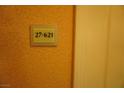 Hallway shot showcasing unit number sign on the wall outside the door to the condo at 145 E Harmon Ave # 27621, Las Vegas, NV 89109