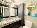 Modern bathroom featuring a glass bowl sink, decorative backsplash, and stylish fixtures at 1515 Fort Dix Cir, North Las Vegas, NV 89031