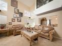 Bright living room with high ceilings, large windows, and comfortable leather sofas at 1515 Fort Dix Cir, North Las Vegas, NV 89031