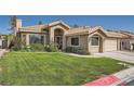 Charming single-story home showcasing a well-maintained lawn, tiled roof, and inviting front entrance at 1609 Hidden Spring Dr, Las Vegas, NV 89117