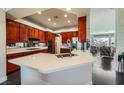 This modern kitchen boasts cherry cabinets, stainless steel appliances, and a sleek white countertop island at 1609 Hidden Spring Dr, Las Vegas, NV 89117