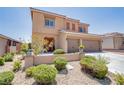 Two story home featuring a spacious two-car garage and well-maintained front yard desert landscaping at 1699 Sonoran Bluff Ave, Henderson, NV 89014