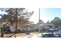 Classic single-story house featuring a quaint facade, mature trees, and a welcoming entrance at 2020 Peyton Dr, Las Vegas, NV 89104