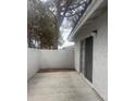 Back patio area that includes a sliding glass door and exterior textured walls at 2108 Willowbury Dr # B, Las Vegas, NV 89108