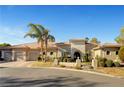 Sprawling single-story home featuring desert landscaping and three-car garage at 2111 Bogart Ct, Las Vegas, NV 89117