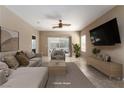 Spacious living room featuring tile floors, a ceiling fan, and sliding glass doors to the backyard at 2708 Cheer Pheasant Ave, North Las Vegas, NV 89084