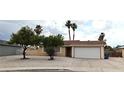 Charming single-story home with a two-car garage, mature trees, and low maintenance landscaping at 275 Las Palmaritas Dr, Las Vegas, NV 89110