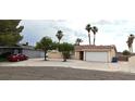 Charming single-story home with a two-car garage, mature trees, and low maintenance landscaping at 275 Las Palmaritas Dr, Las Vegas, NV 89110
