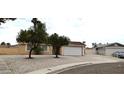 Cozy single-story home with two-car garage, ample driveway, and minimalist landscaping at 275 Las Palmaritas Dr, Las Vegas, NV 89110