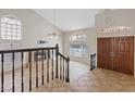 Spacious living room featuring tile floors, a fireplace, arched windows, and high ceilings at 2812 Via Avanti St, Henderson, NV 89074