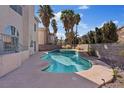 Backyard pool featuring a raised spa with nearby palm trees and rock landscaping at 2812 Via Avanti St, Henderson, NV 89074