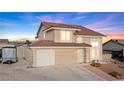 Attractive two-story home with a tile roof, attached garage, and a tidy front yard at 3008 Soledad Dr, Laughlin, NV 89029