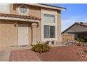 Close-up of a charming home's facade, showcasing the tiled roof and well-maintained yard at 3008 Soledad Dr, Laughlin, NV 89029