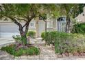 Front entrance with stone steps, lush landscaping, and charming front door at 301 Lakewood Garden Dr, Las Vegas, NV 89148