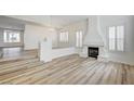 Bright living room featuring wood-style floors, fireplace and shuttered windows at 301 Lakewood Garden Dr, Las Vegas, NV 89148