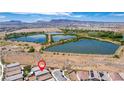 An aerial view showing a home in a location with access to walking paths and several lakes and ponds at 330 Spring Dove Ave, Henderson, NV 89011