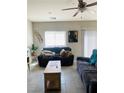 Cozy living room with tile floors, a ceiling fan and recessed lighting creating a warm and inviting ambiance at 330 Spring Dove Ave, Henderson, NV 89011