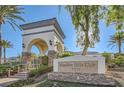 Elegant entrance to the Shadow Hills Club with a stone archway, manicured landscaping, and clear signage at 3412 Crystal Tower St, Las Vegas, NV 89129