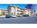 Apartment building showing parking with a view of a building with a portrait on the side at 4200 S Valley View Blvd # 2081, Las Vegas, NV 89103