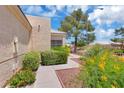 Manicured front yard featuring desert landscaping and charming walkway at 471 Fallwood Ln, Las Vegas, NV 89107