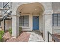 Condo front door with blue door and entry under archway at 4718 Nara Vista Way # 104, Las Vegas, NV 89103