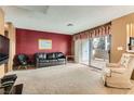 Spacious living room with carpet, couch, and access to patio at 4718 Nara Vista Way # 104, Las Vegas, NV 89103