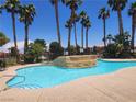 Resort-style community pool surrounded by mature palm trees and landscaping at 4730 E Craig Rd # 1155, Las Vegas, NV 89115