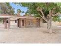 Charming single-story home with a covered patio, complemented by mature trees and desert landscaping at 4805 Jay Ave, Las Vegas, NV 89130