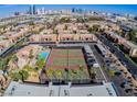 Aerial view of a community featuring tennis courts, a pool, condos, and palm trees at 5185 Indian River Dr # 223, Las Vegas, NV 89103